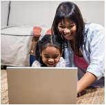Parent and child using a laptop together