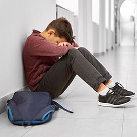 Student seated with teacher support